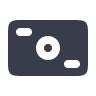 Icon of a camera, depicted in a simple, dark design on a light background.